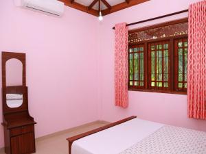 a bedroom with a bed and a window at The Great Water in Ahangama