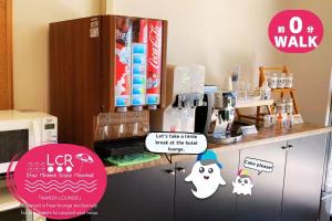 a kitchen with a counter with stickers on it at LOW COST RESORT MANZA BEACH （旧：北海荘） in Onna