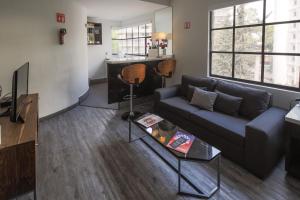 a living room with a couch and a table at FlowSuites Polanco in Mexico City