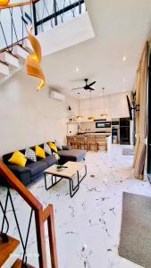 a living room with a couch and a table at Vila Cartenz in Jimbaran
