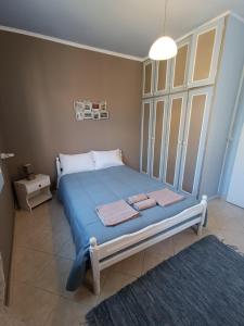 a bedroom with a bed with two towels on it at PENELOPE'S STREET OLD HOUSE in Lefkada