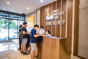 a group of people standing around a counter in a lobby at The Matrix One - Luxury free Gym&Pool in Hanoi +72 photos