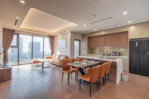 a kitchen and living room with a table and chairs at The Matrix One - Luxury free Gym&Pool in Hanoi