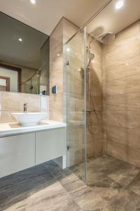 a bathroom with a sink and a shower at The Matrix One - Luxury free Gym&Pool in Hanoi