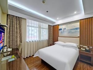 TV a/nebo společenská místnost v ubytování Yiwu Ruifeng Hotel