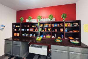 a counter in a restaurant with a red wall at Ramada by Wyndham Sparta/At Speedway in Sparta +31 photos
