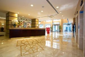 a lobby with a reception desk in a building at Ramada By Wyndham İstanbul Taksim in Istanbul