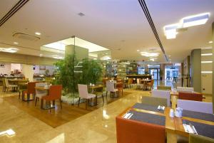a restaurant with tables and chairs in a building at Ramada By Wyndham İstanbul Taksim in Istanbul