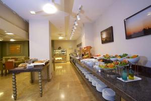 a buffet line in a restaurant with plates of food at Ramada By Wyndham İstanbul Taksim in Istanbul