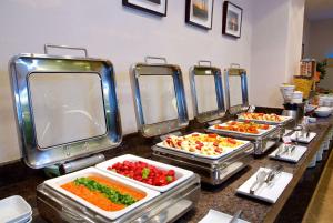 a buffet line with several trays of food at Ramada By Wyndham İstanbul Taksim in Istanbul