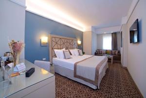 a hotel room with a large bed in a room at Ramada By Wyndham İstanbul Taksim in Istanbul