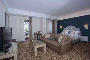 a living room with a bed and a couch at Ramada By Wyndham İstanbul Taksim in Istanbul