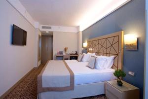 a hotel room with a large bed and a television at Ramada By Wyndham İstanbul Taksim in Istanbul