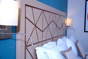 a bedroom with a bed with white pillows at Ramada By Wyndham İstanbul Taksim in Istanbul