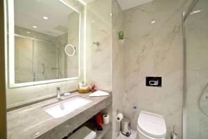 a bathroom with a sink and a toilet and a shower at Ramada By Wyndham İstanbul Taksim in Istanbul