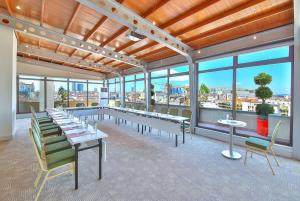a large room with tables and chairs and windows at Ramada By Wyndham İstanbul Taksim in Istanbul