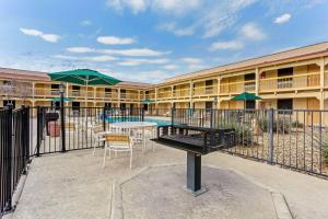 un edificio con piscina, tavolo e sedie di La Quinta Inn by Wyndham and Conference Center San Angelo a San Angelo