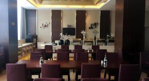 a conference room with tables and purple chairs at Jinjiang Metropolo Fuzhou Cangshan in Fuzhou