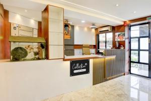 a restaurant with a counter and a sign on the wall at Super Collection O Ghodbunder Road Formerly Sanwith Residency in Sasupāda