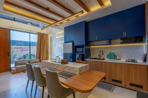 a kitchen with blue cabinets and a table and chairs at Balidian II Residence Loft 2 1 BR in Pesanggaran