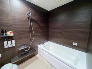 a bathroom with a white tub and a shower at Pal Annex Katsuyama (Love Hotel) in Miyakomachi +25 photos