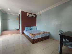 a bedroom with a bed in the corner of a room at Sentosa Villa Hotel in Klang