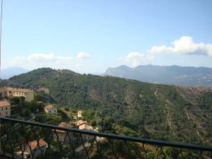 a view of a mountain with houses and trees at Hôtel Restaurant Sole e Monte in Cuttoli-Corticchiato