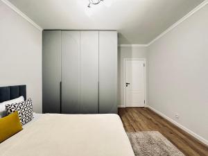 a bedroom with a bed and a closet at Ala Park apartment in Almaty