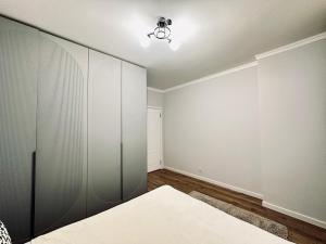 an empty room with a bed and a closet at Ala Park apartment in Almaty
