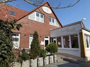 a building with a clock on top of it at Apartmenthaus Leuchtfeuer in Norderney