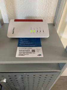 a white router sitting on top of a shelf at Studio 29 in Oberhausen
