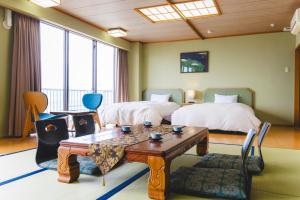Postel nebo postele na pokoji v ubytování Ibusukionsen Hotel Shougetu + 37 fotografií