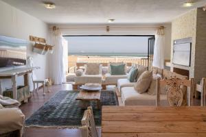 a living room with a view of the ocean at Art Cabin At The Beach in Langstrand