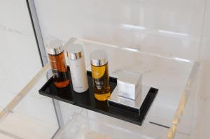 a glass shelf with two bottles of essential oils at Relais12bis Bed & Breakfast By Eiffel Tower in Paris