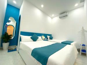 a blue and white bedroom with a large bed at Robinson Homestay - Cù Lao Mái Nhà in Tuy An +32 photos