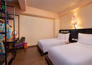 Postel nebo postele na pokoji v ubytování Viva Dash Hotel Seminyak