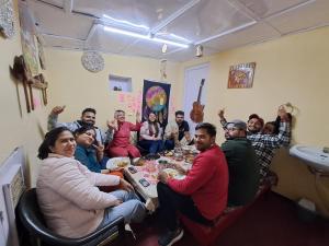 a group of people sitting around a table at Delicate camp in Kīar