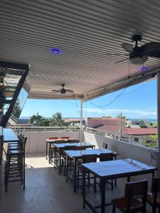 a row of tables and chairs on a balcony at Walk Inn Dipolog City by RedDoorz in Dipolog