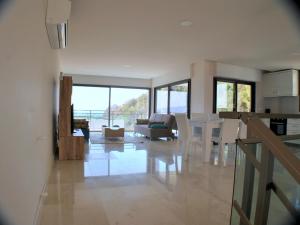 a kitchen and living room with a view of the ocean at Villa Sade in Bodrum City