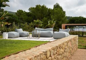 a couch sitting on top of a stone wall at Villa Can Pep de Sa Guaita Amaizing Design & Outdoor Area 10 minutes from beaches Calm Area in Ibiza Town