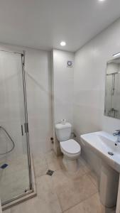 a bathroom with a toilet and a sink and a shower at The birds nest in Tbilisi City +13 photos
