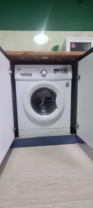 a washer and dryer in a small room at Opera in Bishkek