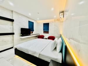 a hotel room with a bed and a television at 168 Hotel in Ho Chi Minh City