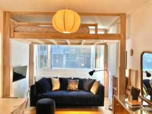 a living room with a couch under a loft bed at Yu's Cozy Home near CityLife in Milan