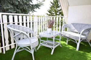 two chairs and a table on a balcony at Kuczkó Apartman in Balatonalmádi