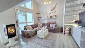 a living room with a couch and a tv at Pink und Meer in Baabe +53 photos