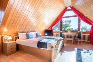 a bedroom with a bed and a large window at Haus Schultz "Traumblick 3" in Hedehusum