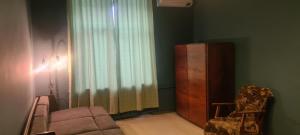 a living room with a couch and a dresser at Opera in Bishkek