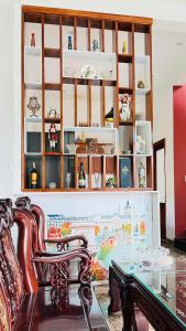 a dining room with a glass table and a chair at Vang's Homestay - Huế in Ấp Long Hồ Hạ