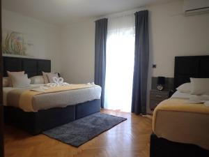 Postel nebo postele na pokoji v ubytování Apartmani NIL